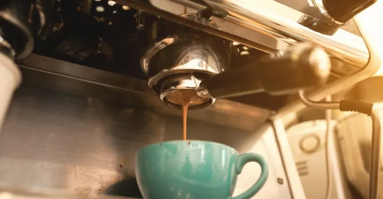 Fresh espresso pouring from a bean-to-cup coffee machine