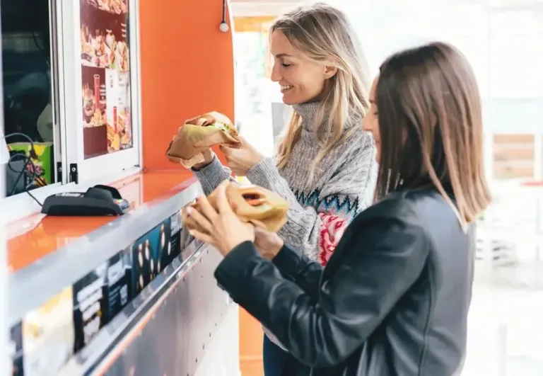 Two employees choosing snacks and drinks at an office micro market